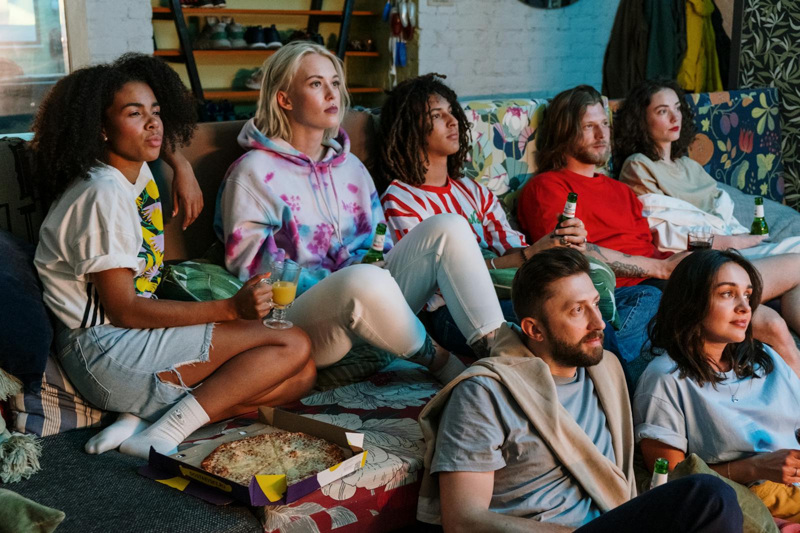 peoples looking netflix while drinking beer and eating pizza